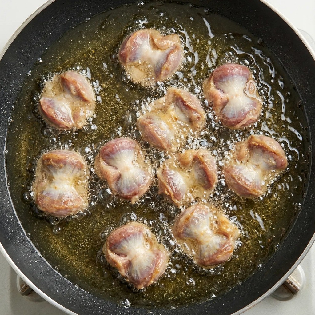 백종원 닭똥집 레시피 - 식용유에 튀기듯이 볶아 잡내 제거하는 모습